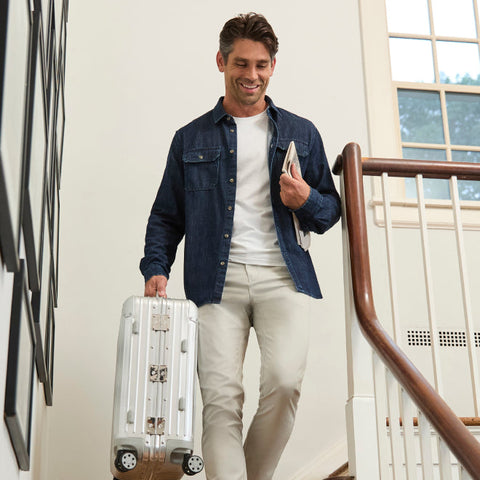 A man wearing the Jetsetter Tech Pant Straight Fit in True Khaki outdoors