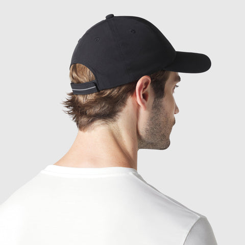 Durable black Anytime Hat with adjustable velcro strap shown from the back.