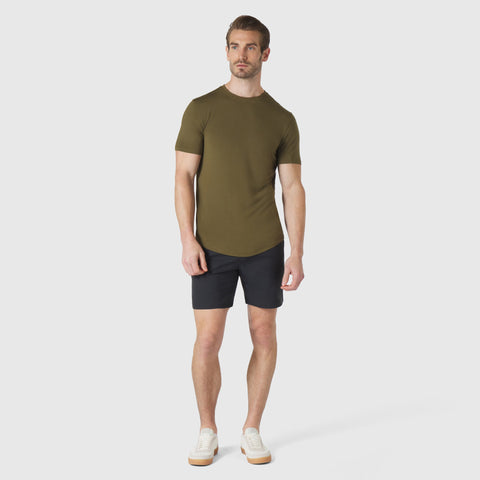 Man wearing Jetsetter Tech Short in navy and green t-shirt, showcasing versatile and durable design.