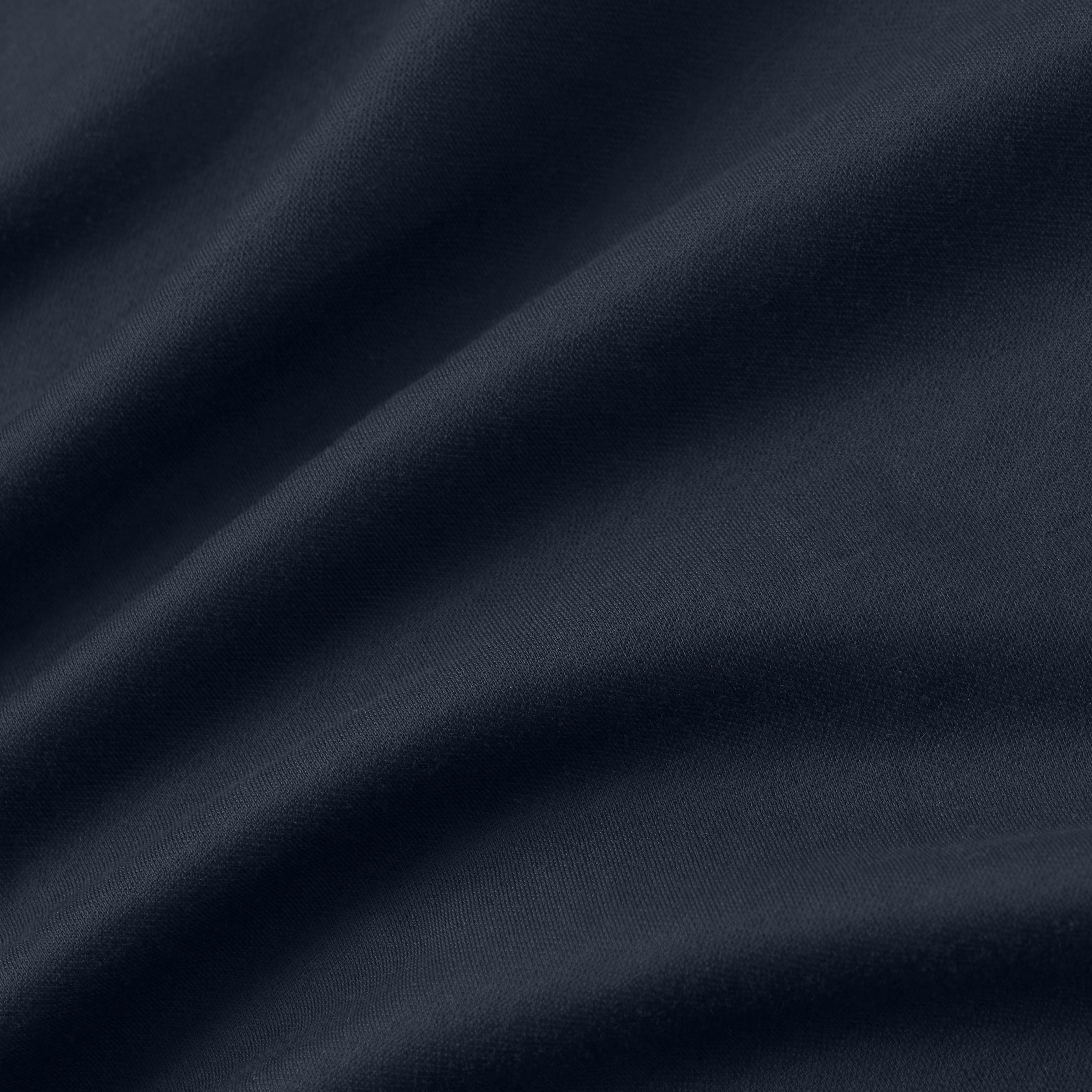 Close-up fabric texture of Tech Polo, showcasing smooth and structured material.