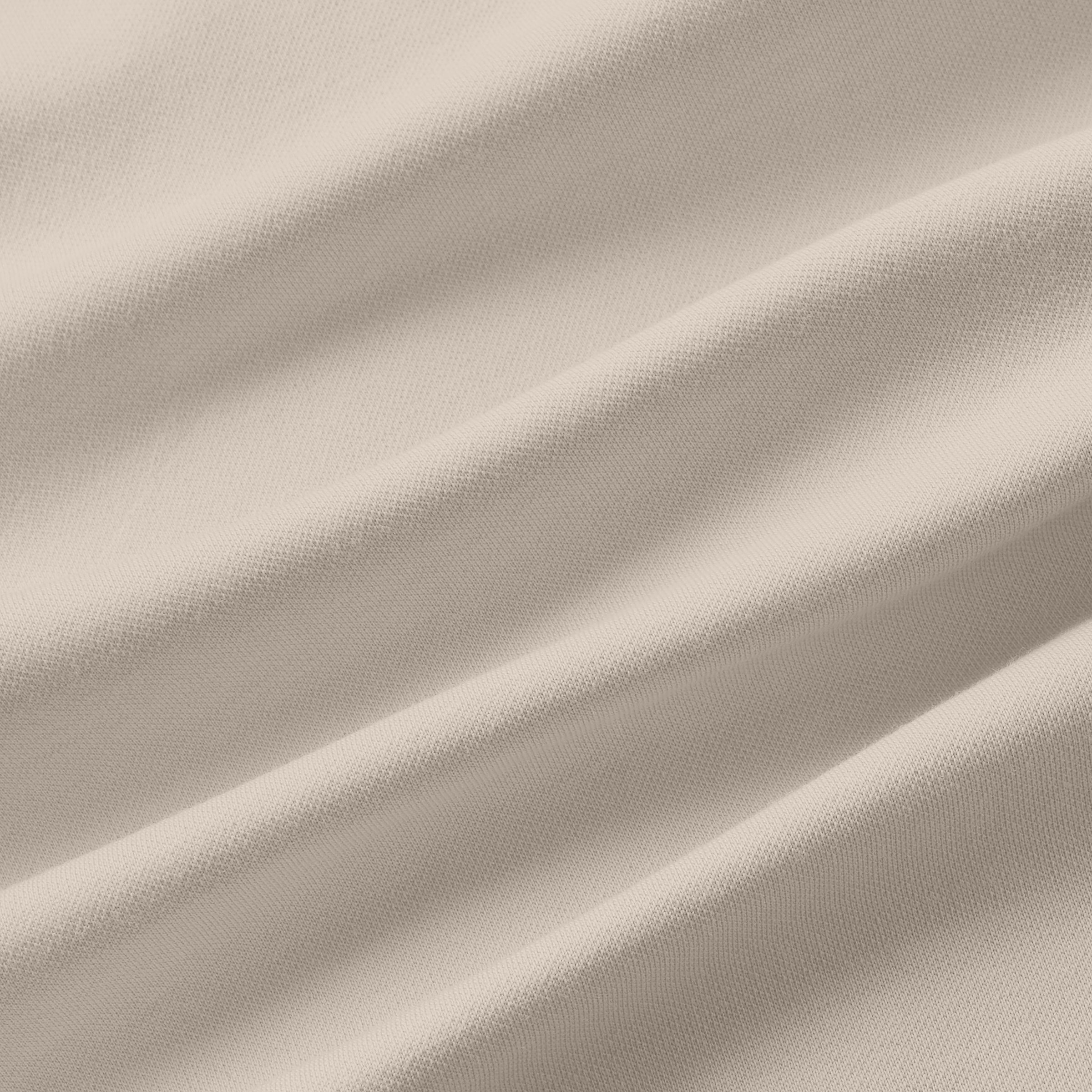 Jetsetter Tech Polo fabric texture in cream color.
