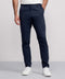A man models the Jetsetter Tech Pant Straight Fit in navy blue against a plain background, paired with a white shirt and white sneakers. Only his lower body and part of his torso are visible.