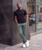 The Jetsetter Tech Pant Straight Fit in Storm Green, worn while sitting