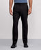 A person wearing Jack Archer Jetsetter Tech Pant Relaxed Fit in True Black stands against a plain gray background. The wrinkle-resistant pants offer a polished look. Image is cropped from the shoulders down.