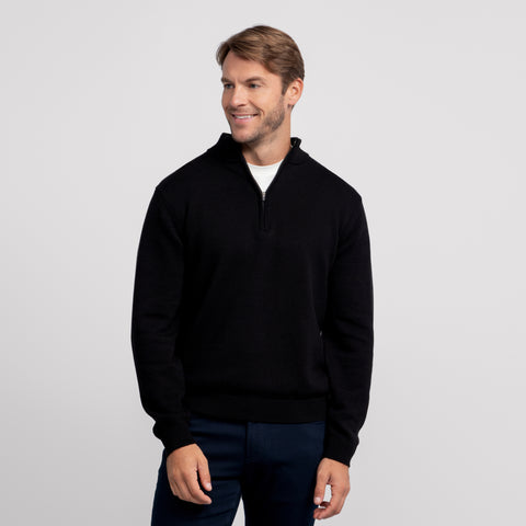 A man wearing the Jetsetter Quarter-Zip Sweater in True Black