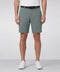 A man wearing the Jetsetter Tech Short 7 inches in Storm Green
