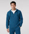 A man wearing the Clubhouse Range Hooded Jacket in Pacific Blue