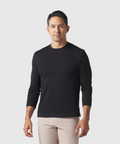 Precision Long Sleeve Tee in organic cotton, black color, modeled by a person, highlighting shoulder design and wrinkle-resistant fabric.