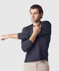 Precision Long Sleeve Tee in organic cotton, emphasizing shoulders, worn by male model stretching arm.