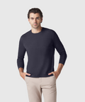 Precision Long Sleeve Tee in organic cotton, modeled by man in beige pants.