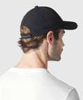Durable black Anytime Hat with adjustable velcro strap shown from the back.