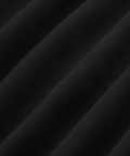 Close-up of black organic cotton fabric from Precision Long Sleeve Tee showcasing soft, wrinkle-resistant texture.