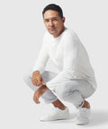 Man wearing white Precision Long Sleeve Tee made from organic cotton, showcasing breathable, wrinkle-resistant fabric.