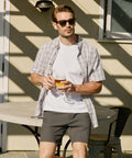 Jetsetter Tech Short worn by a man, showcasing a stylish and comfortable fit ideal for any setting.