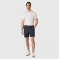 Golf Game Essentials shorts in deep blue, modeled with a white t-shirt.