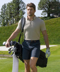 Man wearing Jetsetter Tech Short on a golf course, showcasing a comfortable fit and durable fabric.