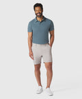 Jetsetter Tech Short on a man wearing a teal polo and white sneakers.