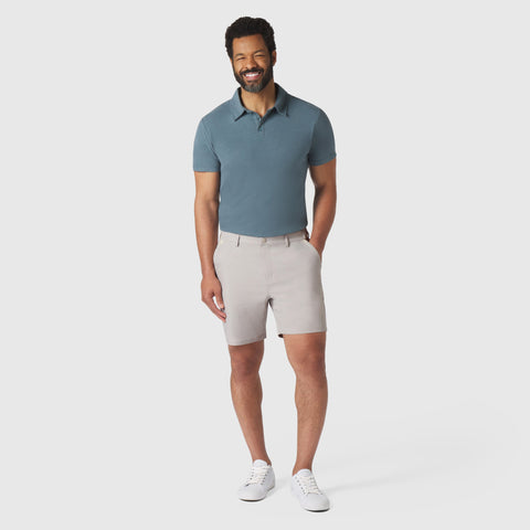 Tech Polo & Shorts Pack featuring deep blue polo and beige shorts, launching soon.