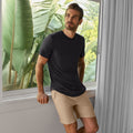 Man wearing Jetsetter Tech Short in a casual indoor setting.