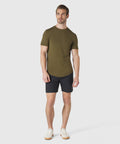 Man wearing Jetsetter Tech Short in navy and green t-shirt, showcasing versatile and durable design.