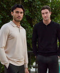 Men wearing Legacy Polo Sweater in cream and black standing outdoors.