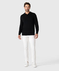 Legacy Polo Sweater in premium viscose blend, modeled with white pants and sneakers.