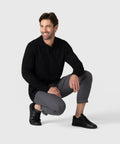 Legacy Polo Sweater worn by model in black, showcasing refined knitwear.