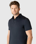Modern man wearing Jetsetter Tech Polo with structured collar and tailored fit.