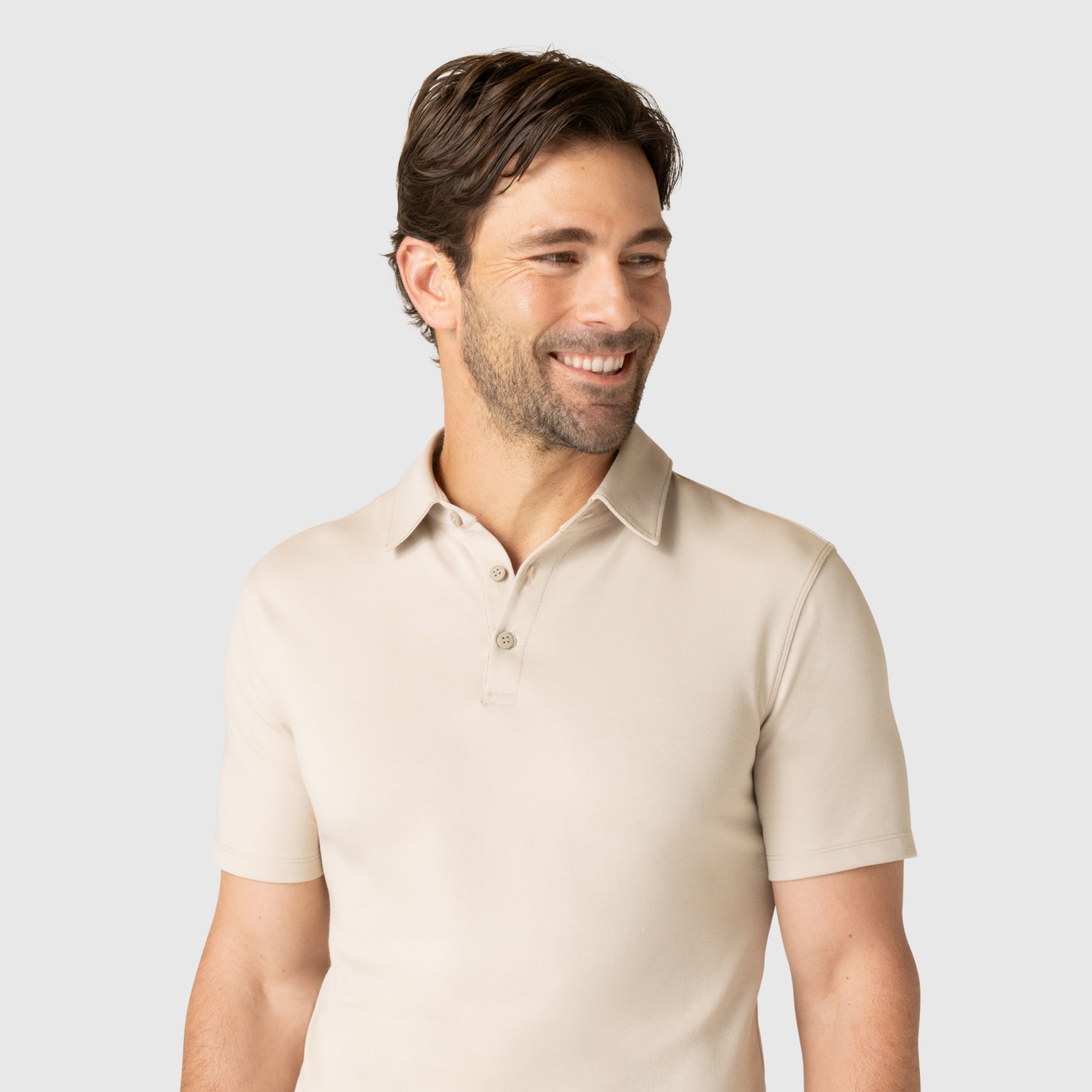 Man wearing Jetsetter Tech Polo with tailored fit and structured collar.