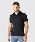 Man wearing black Tech Polo with a tailored fit and structured collar.