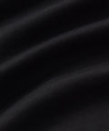 Close-up of black fabric texture, showcasing the smooth material used for the Tech Polo.
