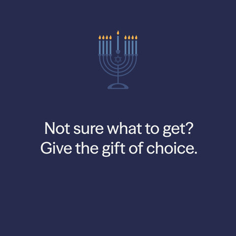Not sure what to get? Give the gift of choice. A lit menorah on a navy background.