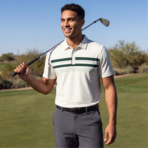 A golfer in a cream polo with green chest stripes and grey pants resting a club on his shoulder.