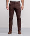 A man wears Jack Archer Jetsetter Tech Pant 3-Pack in brown, paired with a white shirt and brown leather shoes, standing against a light gray background. The image captures him from the chest down with his arms at his sides.