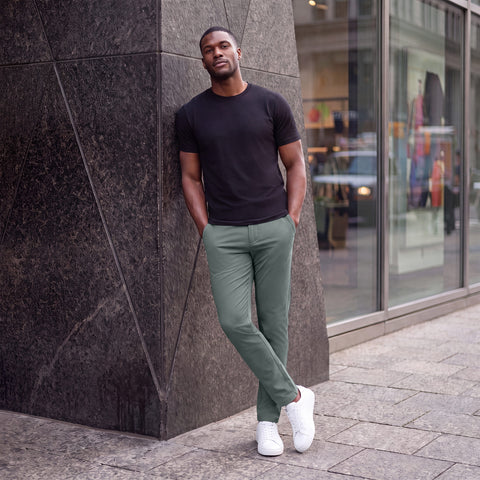 The Jetsetter Tech Pant Slim Fit in Storm Green, worn while sitting