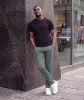 The Jetsetter Tech Pant Straight Fit in Storm Green, worn while sitting