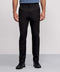 A person, shown from the waist down against a light background, wears Jack Archer’s Jetsetter Tech Pant 3-Pack in black along with black sneakers and a blue shirt.