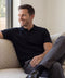 A man wearing the Legacy Resort Polo in True Black.
