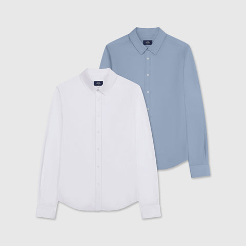 Two button-down shirts laid flat: white and slate blue.