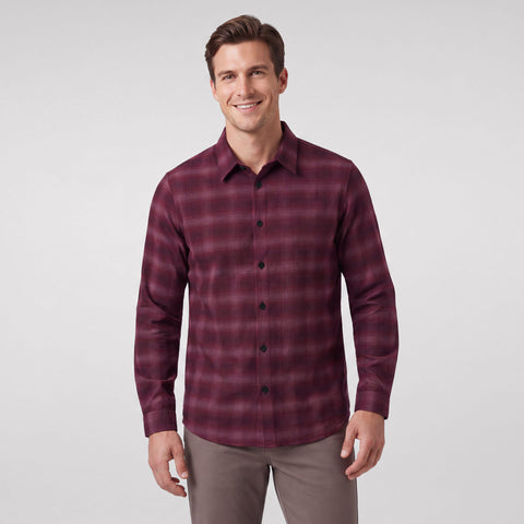 A man wearing the Anytime Plaid Shirt in Burgundy Heritage Plaid