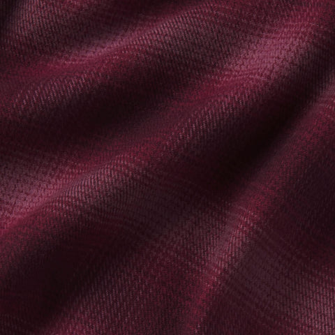 A man in the Anytime Plaid Shirt, Burgundy Heritage, seated