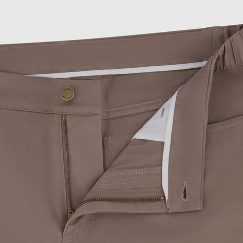 A man wearing Charter Twill Pant in Deep Taupe in an outdoor lifestyle setting.