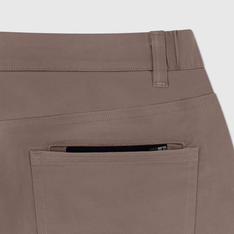 A man wearing Charter Twill Pant in Deep Taupe in a casual lifestyle setting.