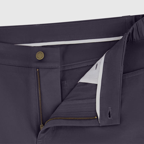 A man in the Charter Twill Pant, Midnight, seated