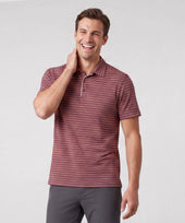 A man wearing Jack Archer Clubhouse Performance Polo in Maroon Stripe against a light background.