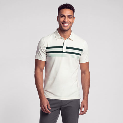 A cream polo with dark green and sage chest stripes, worn with grey pants.