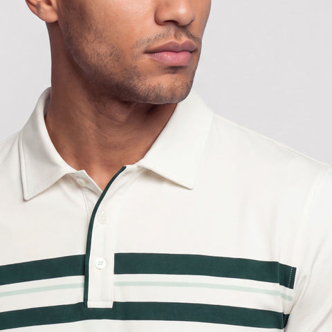 Close-up of the collar and button placket on a cream polo with green chest stripes.