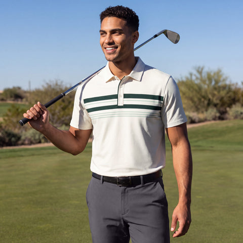 A golfer in a cream polo with green chest stripes and grey pants resting a club on his shoulder.