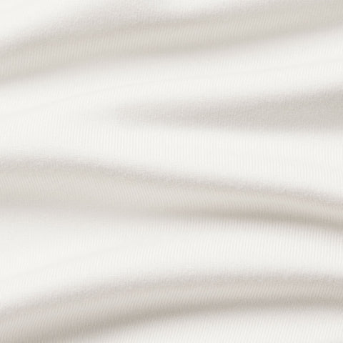 Close-up of the polo's smooth cream performance knit.