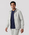 A man wearing the Clubhouse Range Hooded Jacket in Vapor Gray